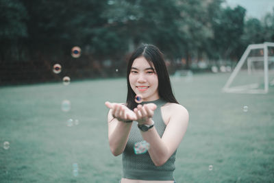Portrait of a smiling young woman standing outdoors