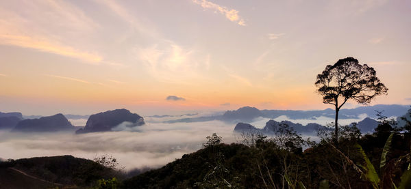 Scenic view of silhouette mountains against sky at sunset