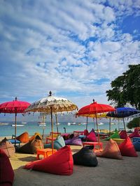 Umbrellas on beach against sky