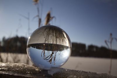 Close-up of crystal ball against clear sky
