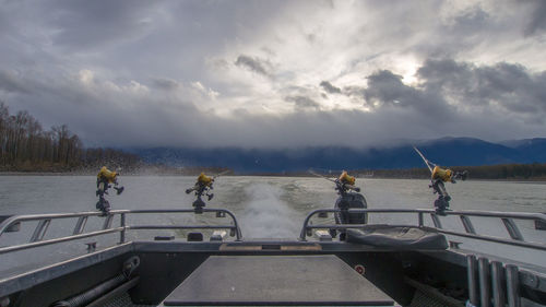 People on boat against sky