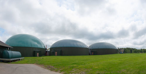 Built structure on field against sky