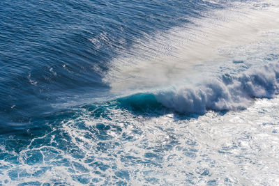 Close-up of sea waves against blue sky