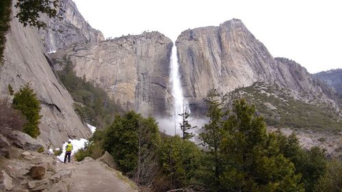 Scenic view of waterfall against sky