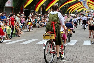 People riding bicycles on street in city
