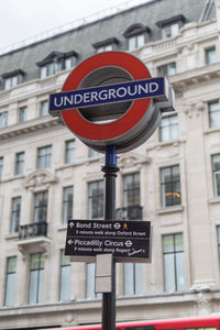 Low angle view of road sign against building