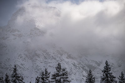 Scenic view of snow covered mountains against sky