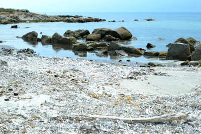 Rocks on beach against sky