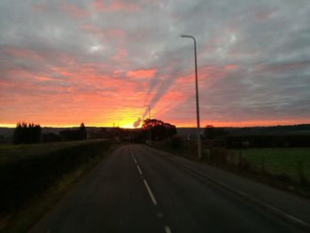 Highway against dramatic sky during sunset