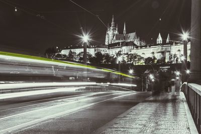 Light trail on street against church at night