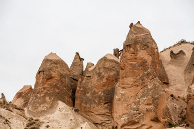 Low angle view of rock formations against sky