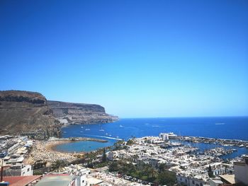 Aerial view of bay against clear blue sky