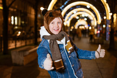 Caucasian school-age boy on a christmas walk around the city, evening december