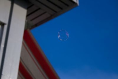 Low angle view of moon against blue sky