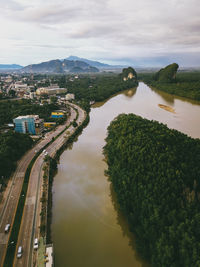 High angle view of river amidst city against sky