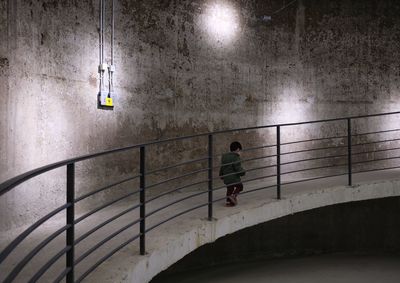 Rear view of woman walking on staircase