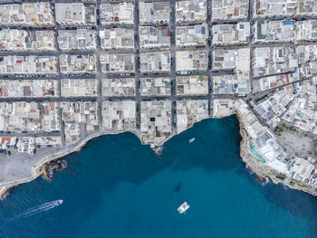 High angle view of swimming pool by buildings in city