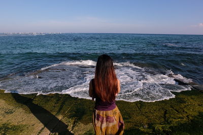 Rear view of man looking at sea