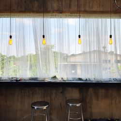 Empty chairs and table against wall