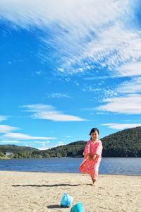 Full length of woman on land against blue sky
