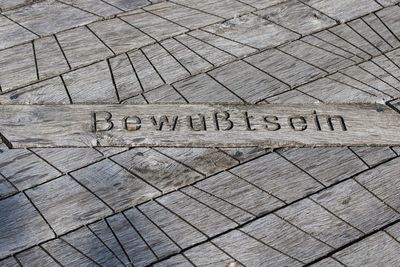 High angle view of text on footpath