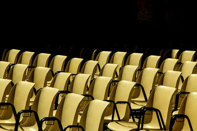 Empty chairs arranged in row