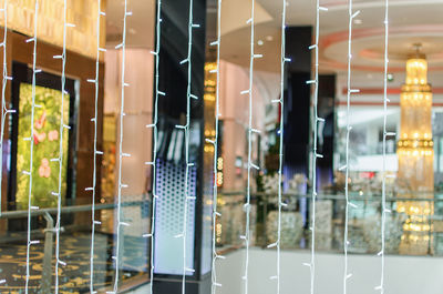 Reflection of illuminated glass window in store