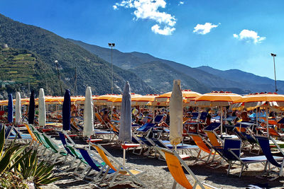 Chairs on beach against sky