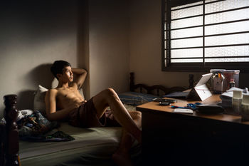 Man sitting on sofa at home