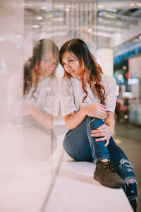 Happy woman sitting on floor