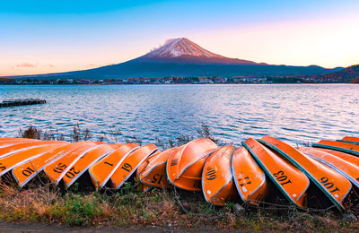 Scenic view of lake and mt fuji against sky during sunset