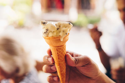 Cropped image of hand holding ice cream