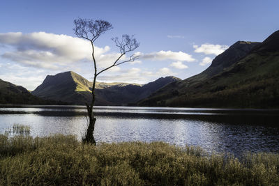 Scenic view of lake and mountains against sky