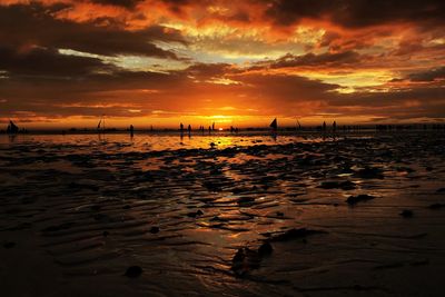 Scenic view of beach against sky during sunset