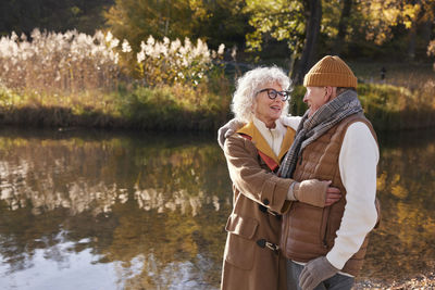 Senior couple next to lake in park