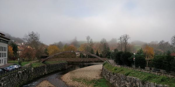 Bridge over canal against sky