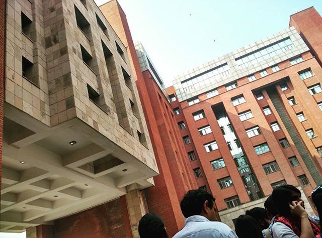 WOMAN STANDING IN FRONT OF BUILDING