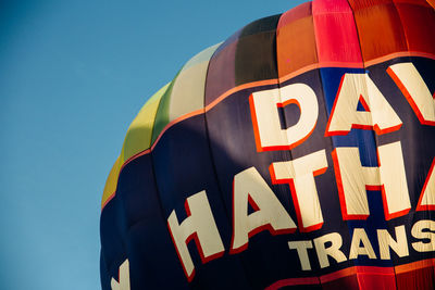 Low angle view of balloons against blue sky