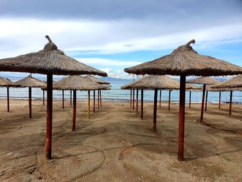 Gazebo on beach against sky