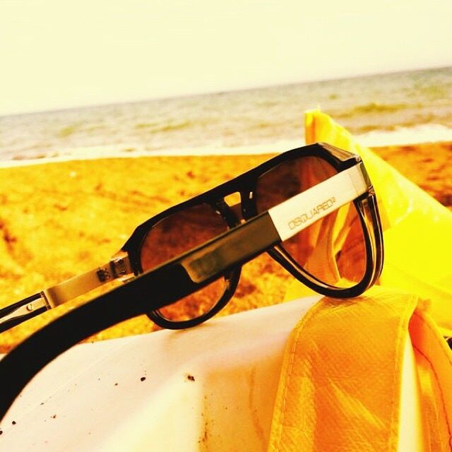 transportation, mode of transport, part of, cropped, close-up, yellow, travel, focus on foreground, clear sky, sunglasses, sunset, sunlight, land vehicle, car, horizon over water, sea, beach, air vehicle