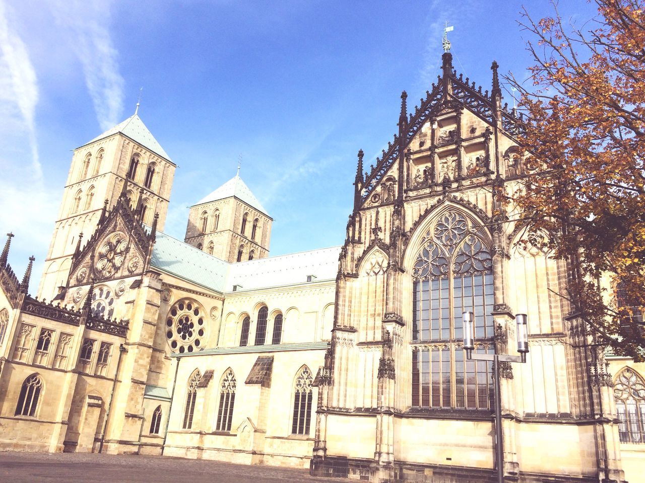 architecture, place of worship, religion, building exterior, church, spirituality, built structure, low angle view, cathedral, sky, blue, cross, famous place, facade, travel destinations, sunlight, history, day