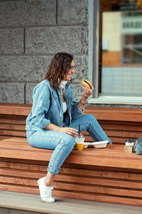 Full length of a woman sitting outdoors