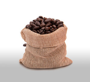 Close-up of coffee beans against white background