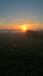 Scenic view of landscape against sky during sunset