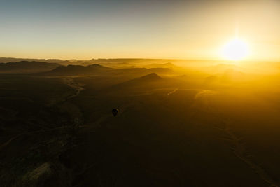 Scenic view of silhouette landscape against sky during sunset