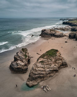 Scenic view of rocks on beach against sky