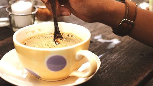 Woman stirring coffee