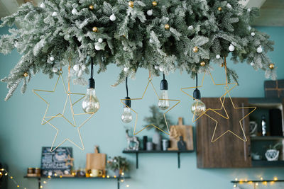 Incandescent lamps among the christmas garland in the kitchen, decorated for christmas and new year