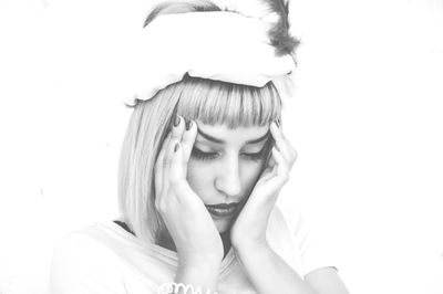 Close-up of woman against white background