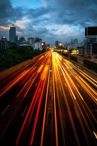 High angle view of light trails on highway at night